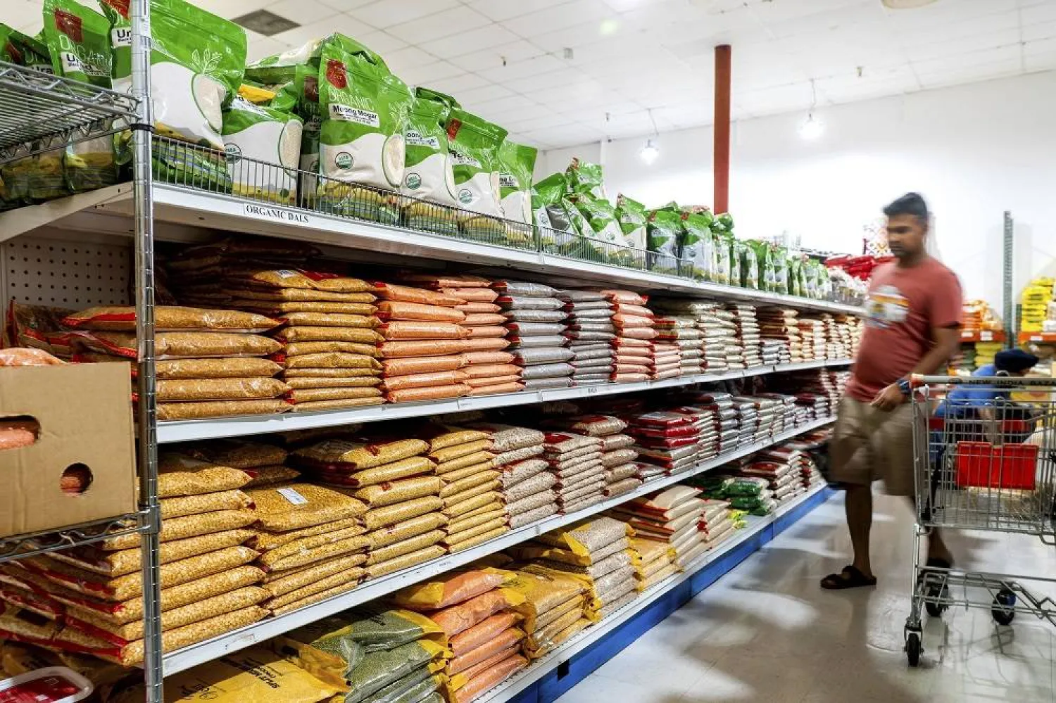 A customer shops a grain aisle at New India Bazar, where most merchandise is imported from India and Canada, on Wednesday, Aug. 6, 2025, in Fremont, Calif. (AP)