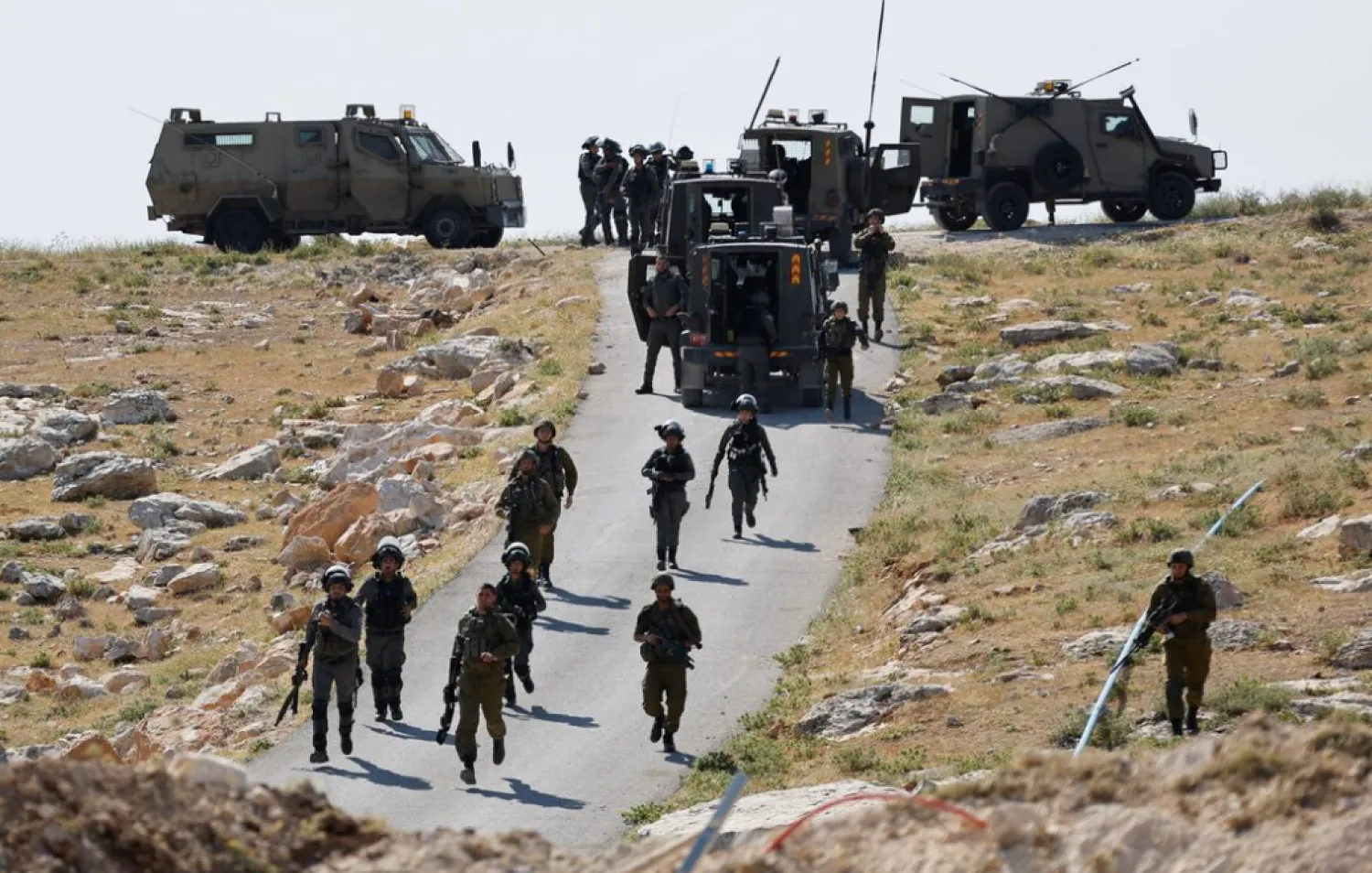 Israeli troops take position during clashes between Palestinians and Israeli troops after Israeli machinery demolish a school near Bethlehem in the Israeli-occupied West Bank May 7, 2023. REUTERS/Mussa Qawasma 