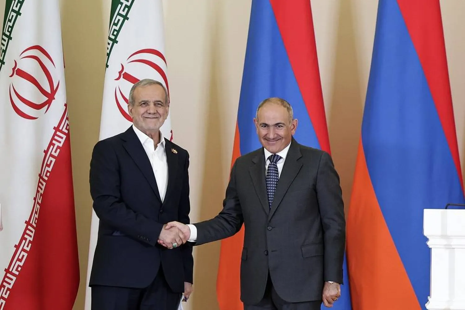 A handout photo made available by the Armenian Prime Minister's office shows Armenian Prime Minister Nikol Pashinyan (R) and Iranian President Masoud Pezeshkian shaking hands as they attend a press conference during their meeting in Yerevan, Armenia, 19 August 2025. (EPA/ Armenian Prime Minister Press Service / Handout) 