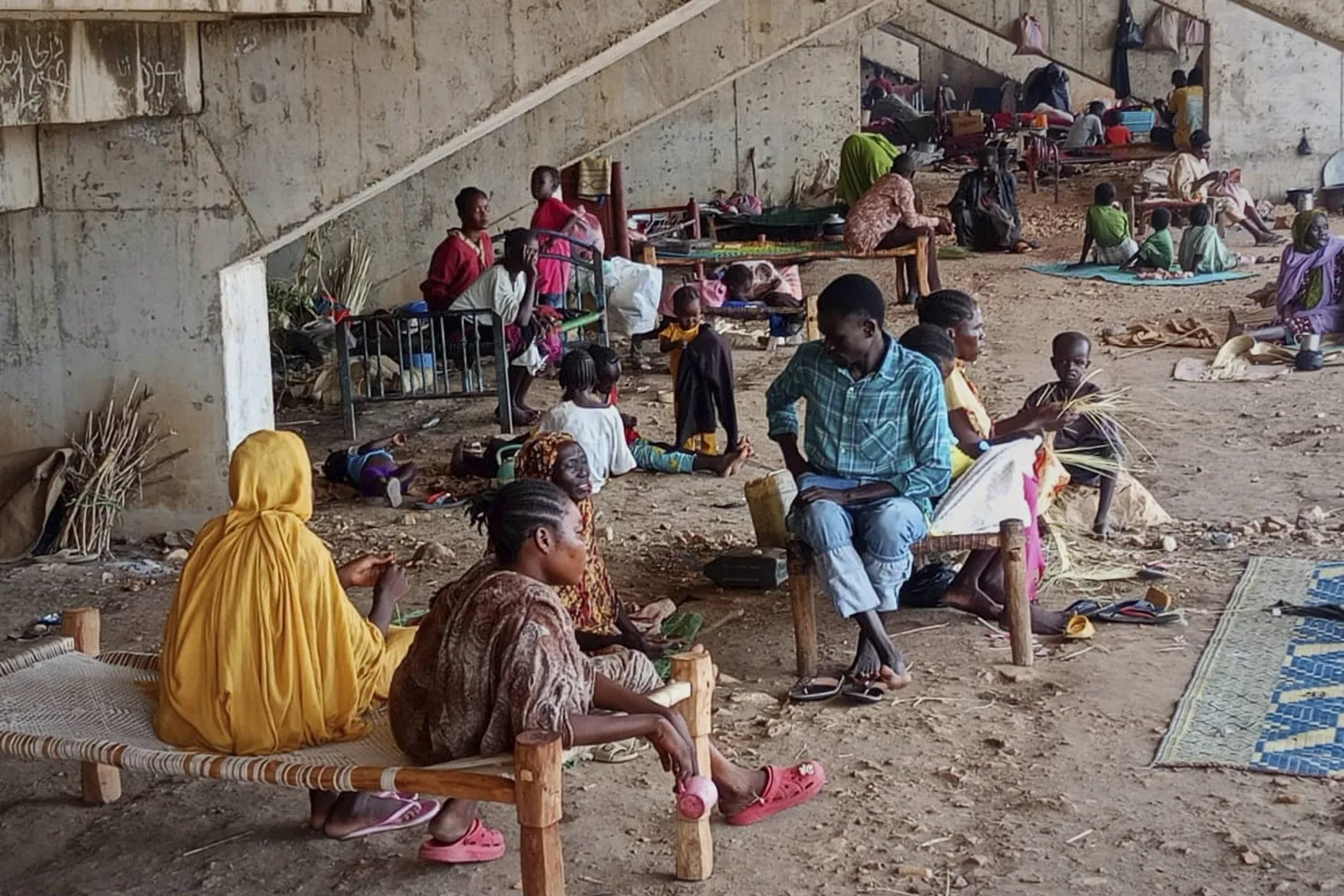 In this photo released by the NGO Mercy Corps, Sudanese families displaced by RSF attacks in Kordofan take shelter in a football stadium in Kadugli, South Kordofan province, Sudan, May 27, 2025. (Mercy Corps via AP)