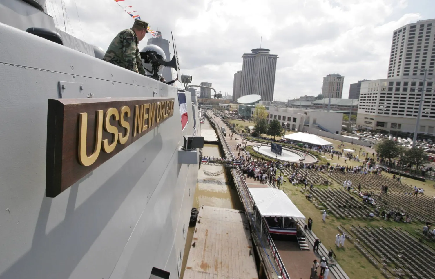 FILE - People line up to come aboard the USS New Orleans after a commissioning ceremony for the vessel in New Orleans, March 10, 2007. (AP Photo/Alex Brandon, File)