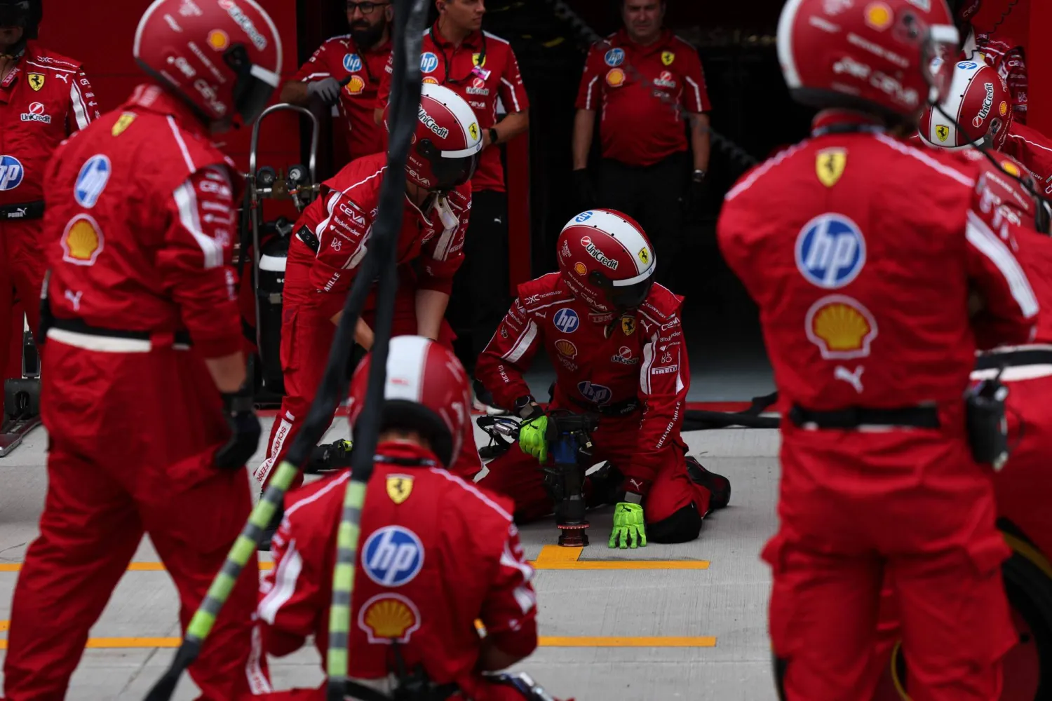 Ferrari team's technicians get ready at the pits' stops during the Formula One Hungarian Grand Prix at the Hungaroring circuit in Mogyorod near Budapest, Hungary, on August 3, 2025. (Photo by ANNA SZILAGYI / POOL / AFP)