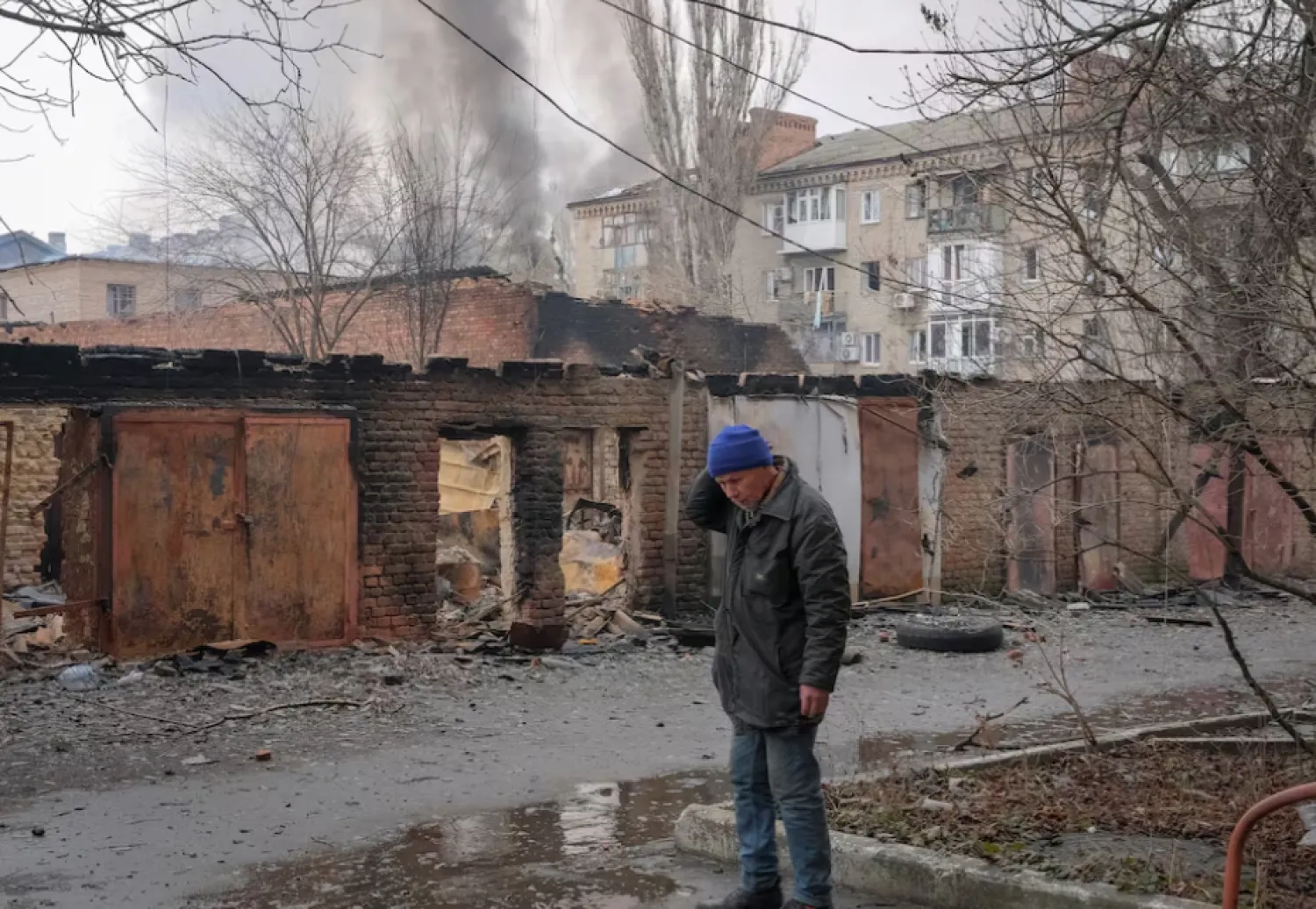 A local resident stands near buildings damaged by a Russian military strike, amid Russia's attack on Ukraine, in the frontline city of Bakhmut, in Donetsk region, Ukraine February 27, 2023. REUTERS/Alex Babenko 