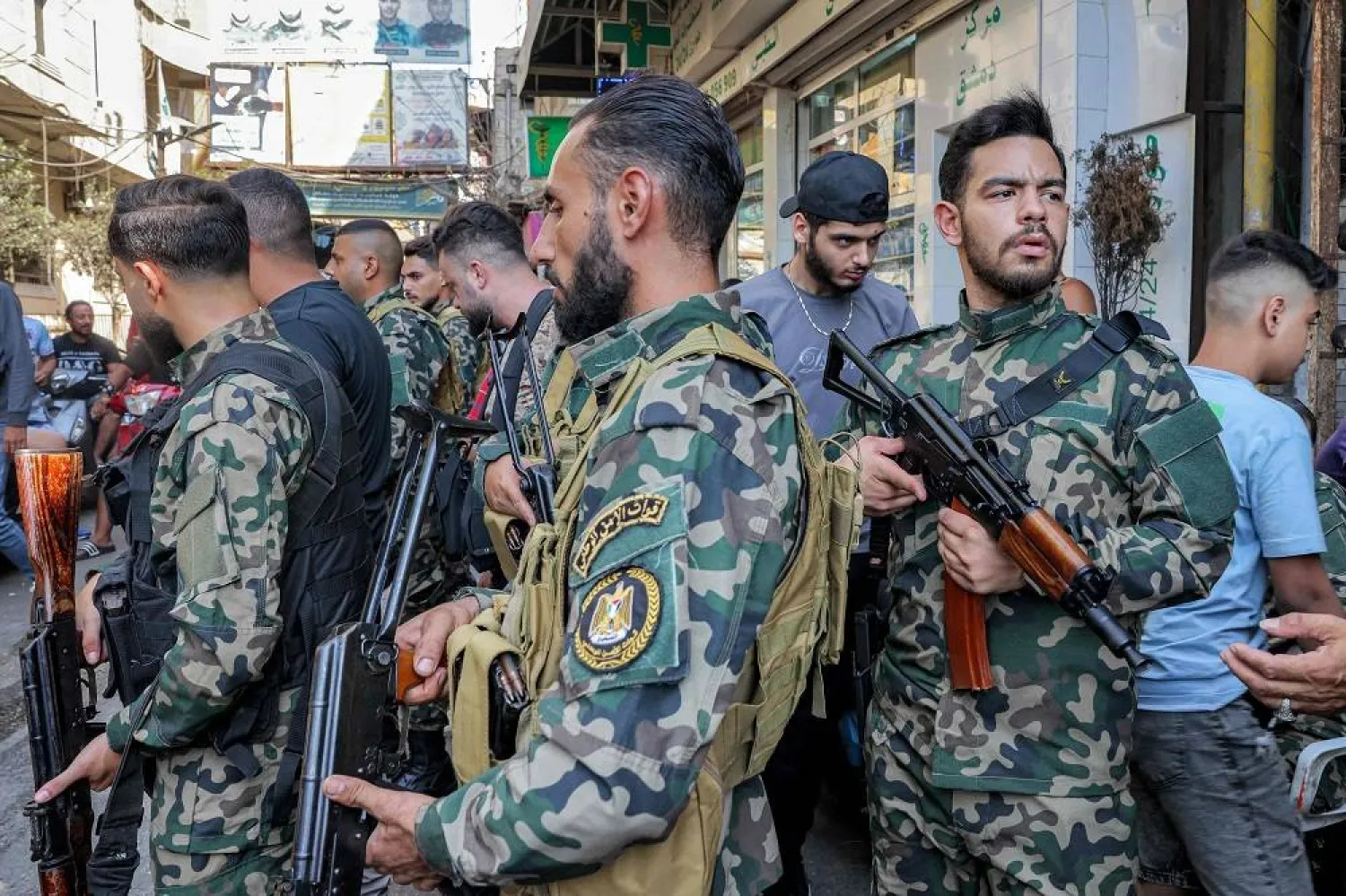 Palestinian fighters stand with their arms in the Burj al-Barajneh camp for Palestinian refugees in Beirut's southern suburbs on August 21, 2025 as the armed Palestinian groups in the camps start handing over their weapons to the Lebanese authorities following a deal reached in May. (AFP) 