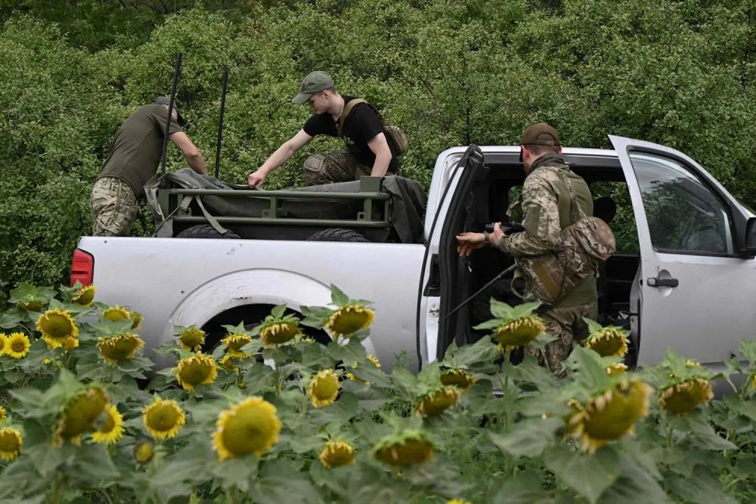 Ukrainian servicemen from the 5th Separate Assault Brigade load an unmanned ground vehicle on a pickup on a training ground at an undisclosed location in eastern Ukraine on August 11, 2025, amid the Russian invasion of Ukraine. (AFP)