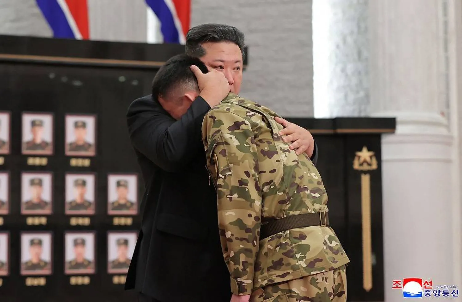 This undated picture released from North Korea's official Korean Central News Agency (KCNA) on August 22, 2025 shows North Korean leader Kim Jong Un (L) embracing a serviceman as he attends a ceremony to award state commendations to the commander and combatants of the Korean People's Army's Overseas Operational Forces, who took part in military operations in Kursk Oblast to help Russia in its war against Ukraine, at the headquarters building of the Central Committee of the Workers' Party of Korea (WPK) in Pyongyang. (KCNA via KNS / AFP) 