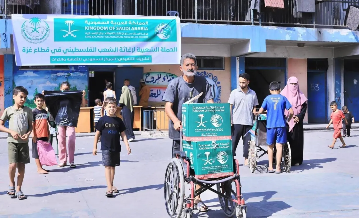 أسر فلسطينية لدى تسلمها سلالاً غذائية قدّمتها السعودية لسكان قطاع غزة (واس)