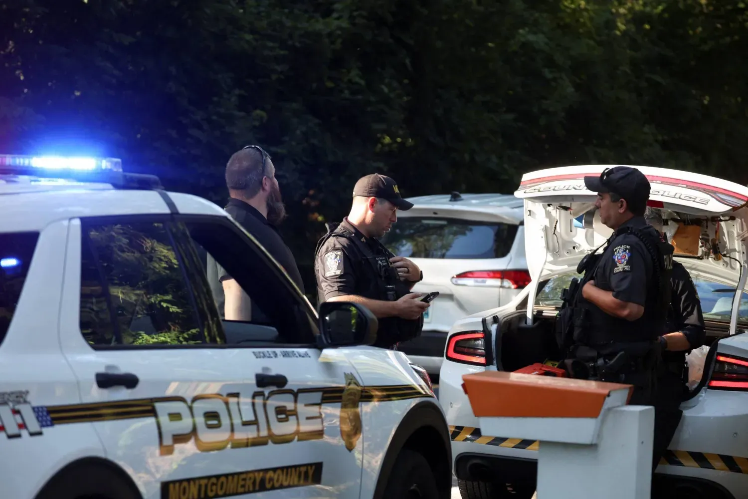 Polis memurları, 22 Ağustos'ta eski Beyaz Saray Ulusal Güvenlik Danışmanı John Bolton'ın evinin önünde duruyor. (Reuters)