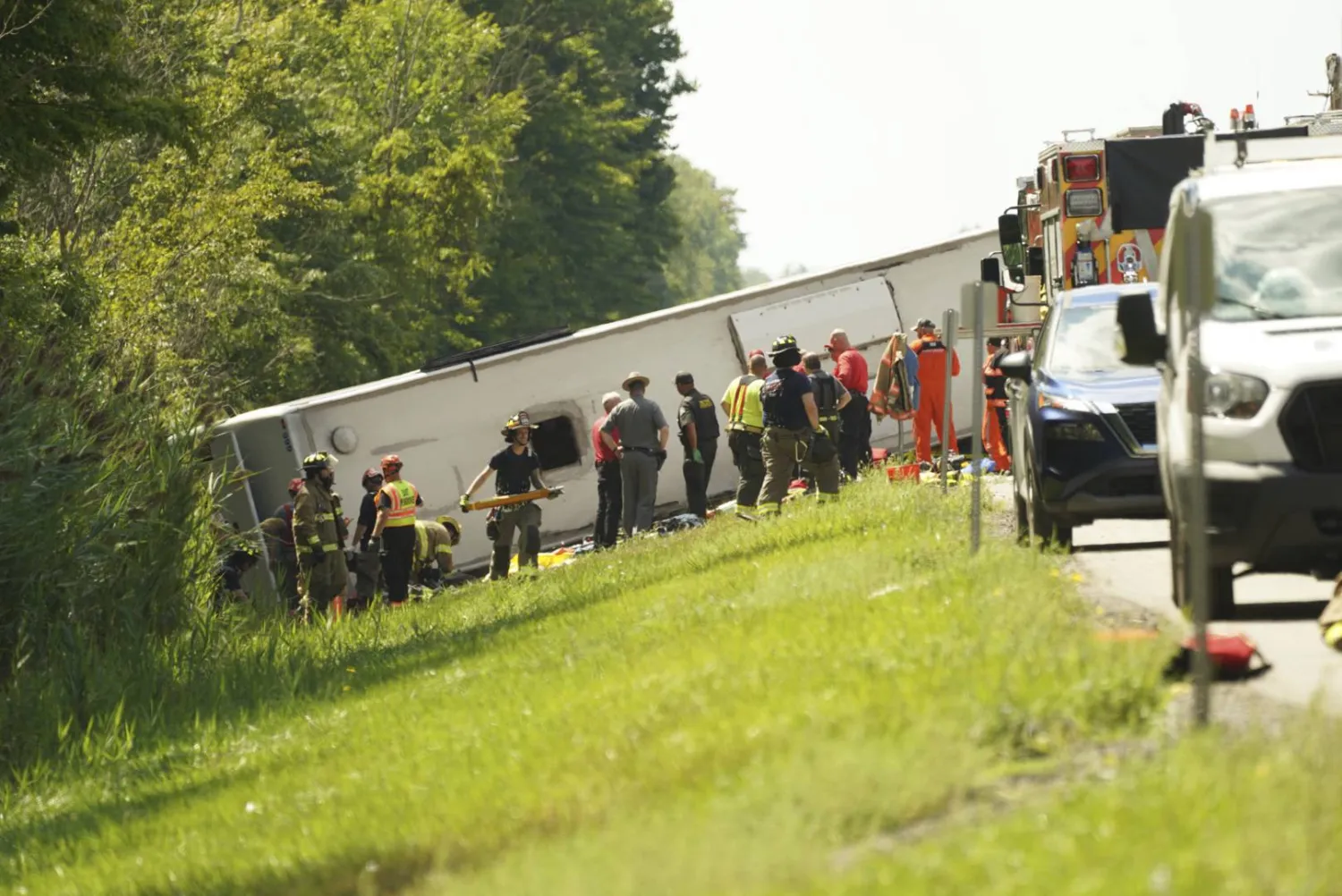 First responders work to rescue victims at the scene of a tour bus that crashed and rolled over on the New York State Thruway near Pembroke, N.Y., Friday, Aug. 22, 2025. (Libby March/Buffalo News via AP)
