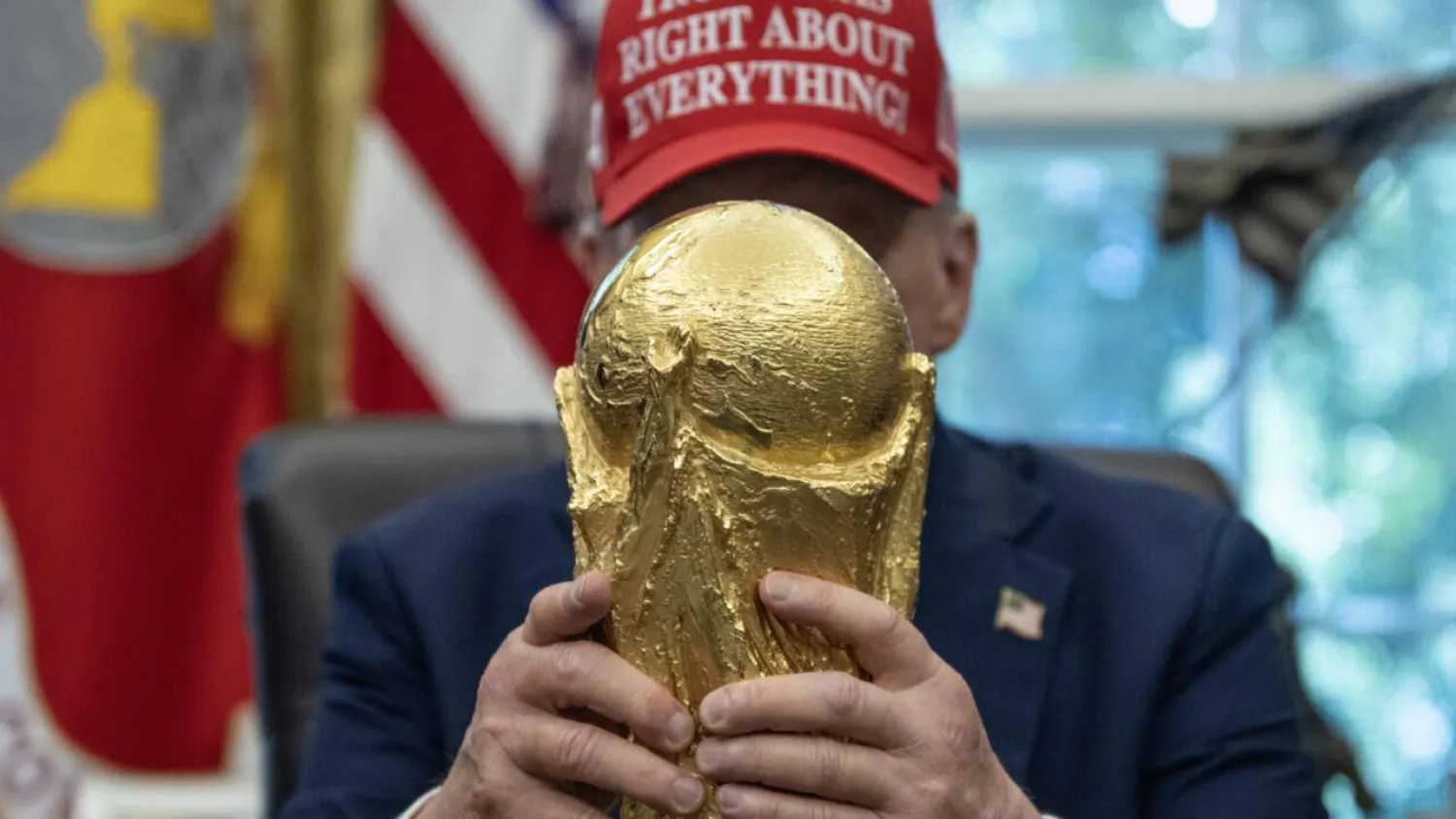 US President Donald Trump holds the World Cup trophy -- he announced the 2026 World Cup draw will be held on December 5, 2025 at Washington's Kennedy Center. ANDREW CABALLERO-REYNOLDS / AFP
