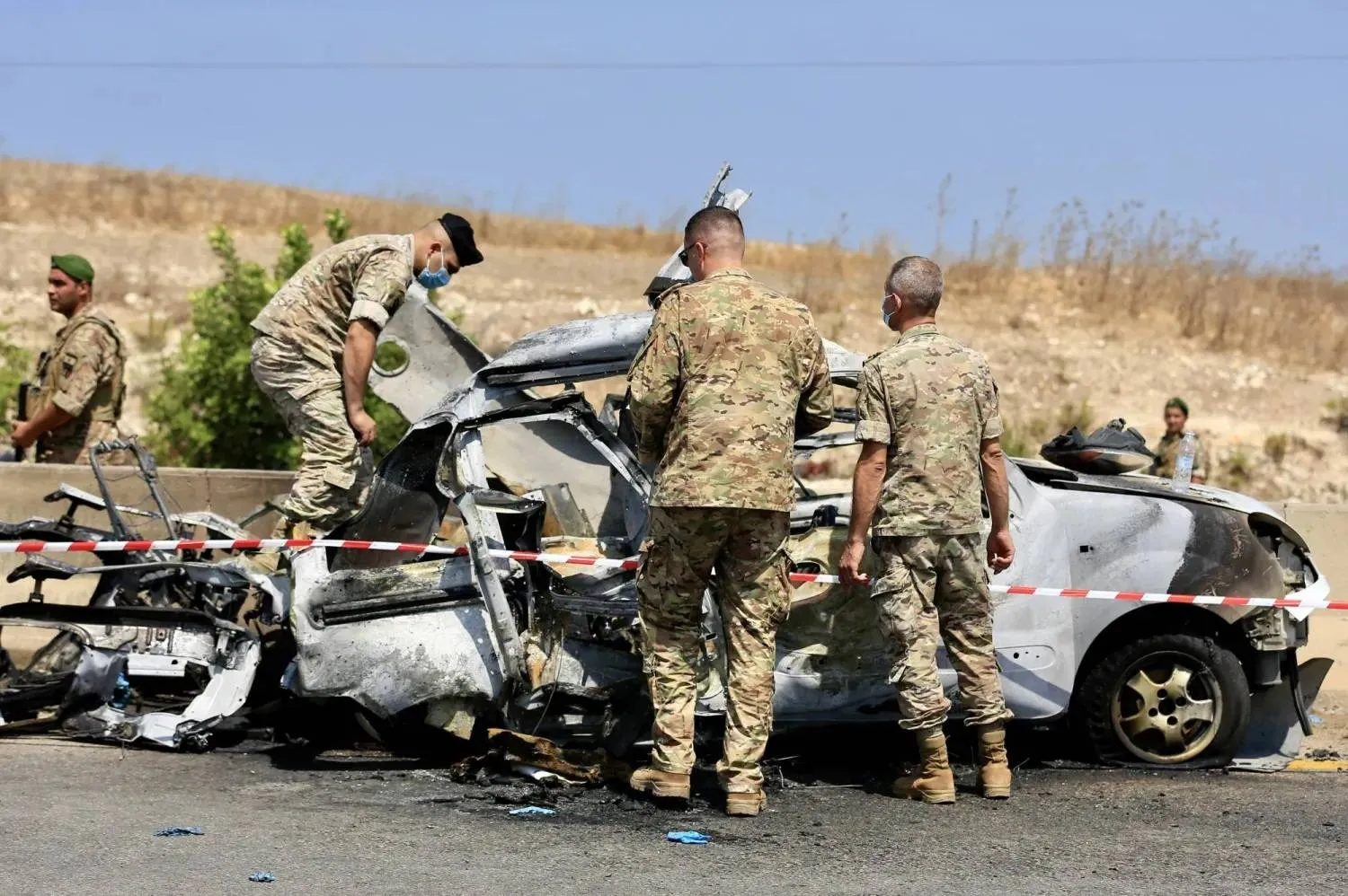 Lebanese soldiers inspect a vehicle that was struck by an Israeli drone in the South on August 8. (EPA) 