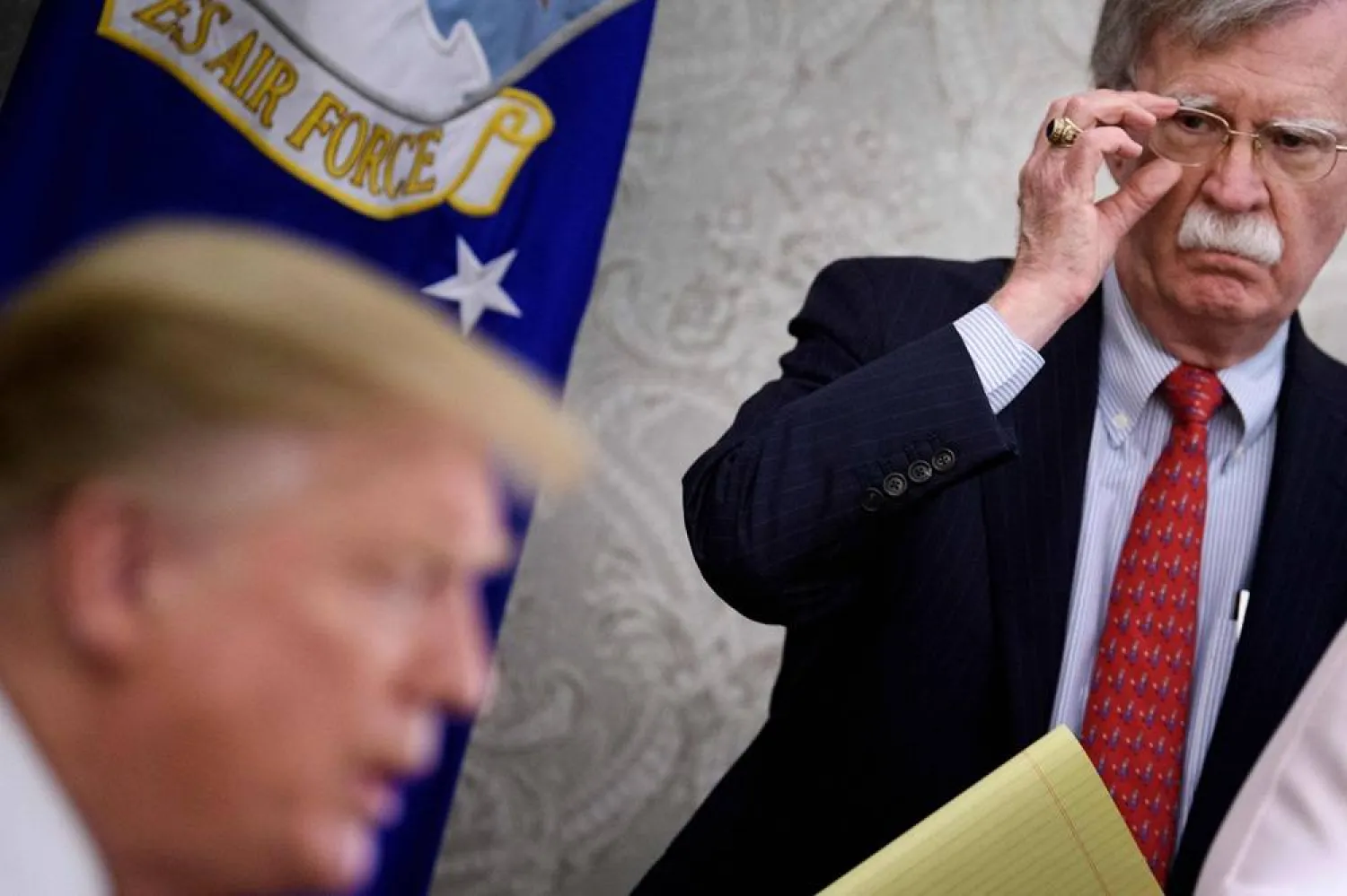 National Security Adviser John R. Bolton listens while US President Donald Trump speaks to the press before a meeting with Hungary's Prime Minister Viktor Orban in the Oval Office of the White House on May 13, 2019, in Washington, DC. (AFP)