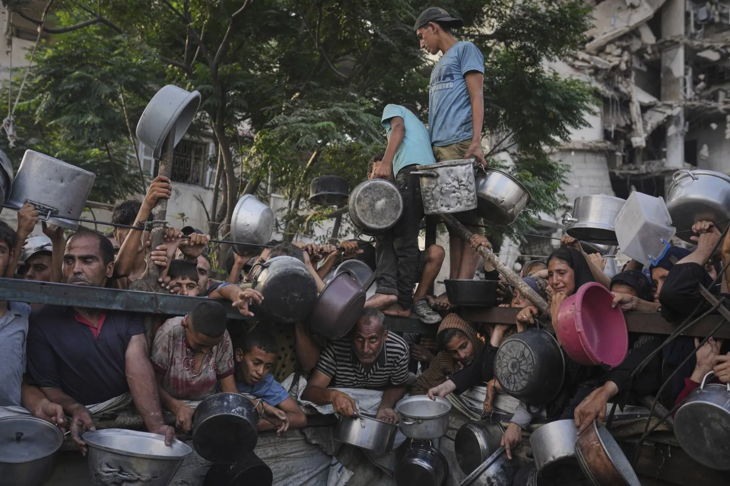 فلسطينيون يكافحون للحصول على الطعام المتبرَّع به في مطبخ خيري شمال قطاع غزة (أ.ب)