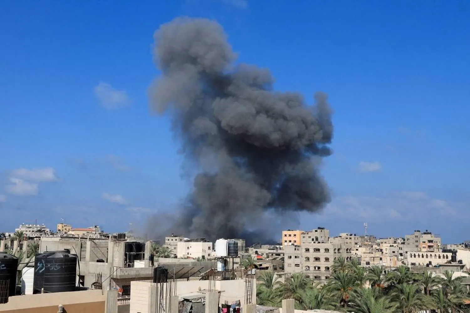 Smoke rises following an Israeli strike, in Deir al-Balah, in the central Gaza Strip, August 23, 2025. (Reuters)