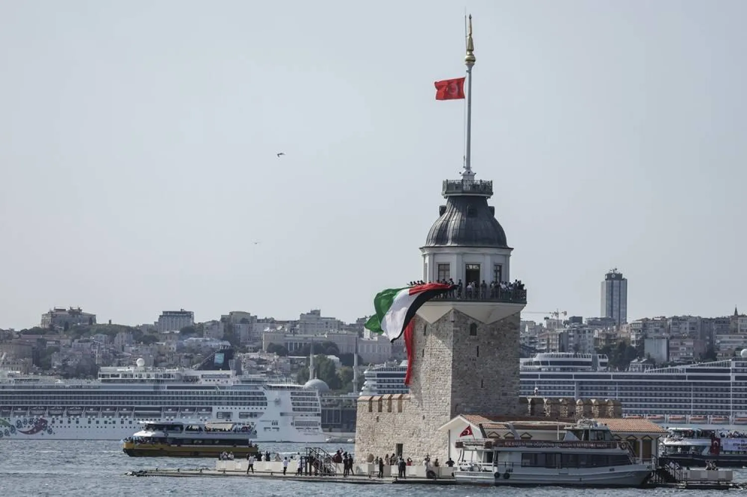 Protesters wave Turkish and Palestinian flags from the Maiden's Tower during a protest in support of the Palestinian people, in Istanbul, Türkiye, 23 August 2025. (EPA) 