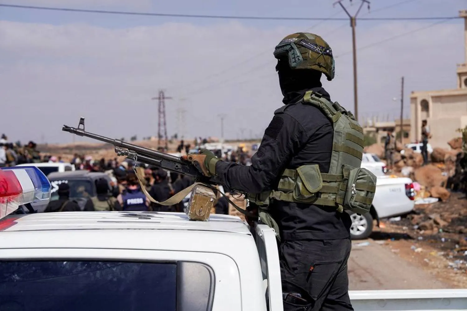 A member of Internal Security Forces holds a gun at an Internal Security Forces' checkpoint working to prevent Bedouin fighters from advancing towards Sweida, following renewed fighting between Bedouin fighters and Druze gunmen, despite an announced truce, in Walgha, Sweida province, Syria, July 20, 2025. (Reuters) 