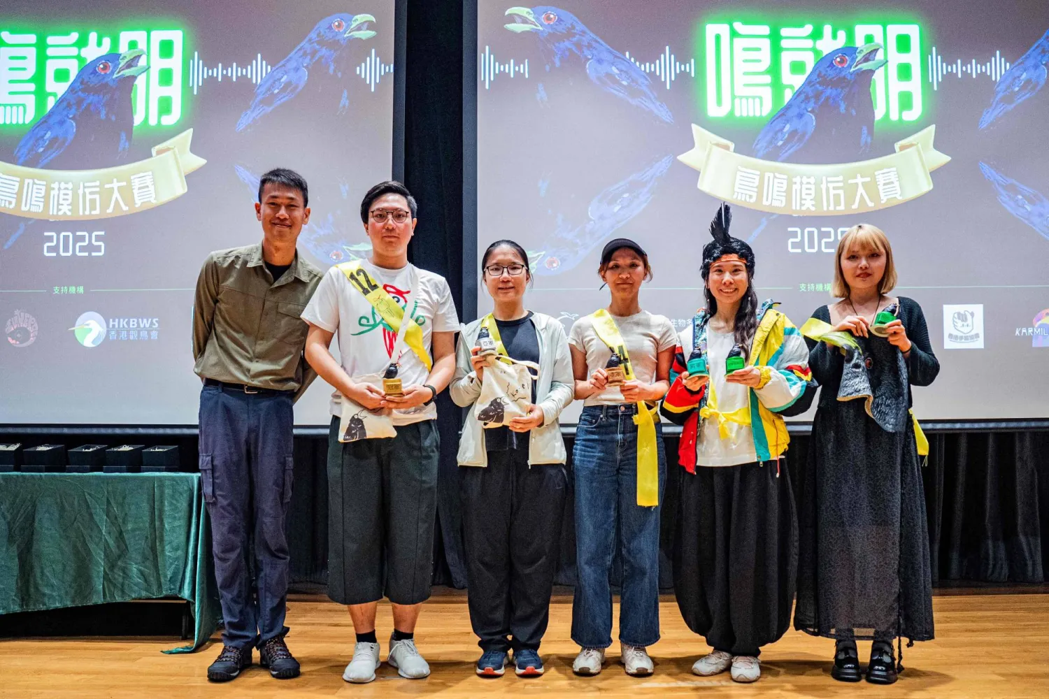Winners hold their trophy following their imitation of bird calls during the Hong Kong Bird Watching Society’s competition at the University of Hong Kong on August 23, 2025. (Photo by Leung Man Hei / AFP)