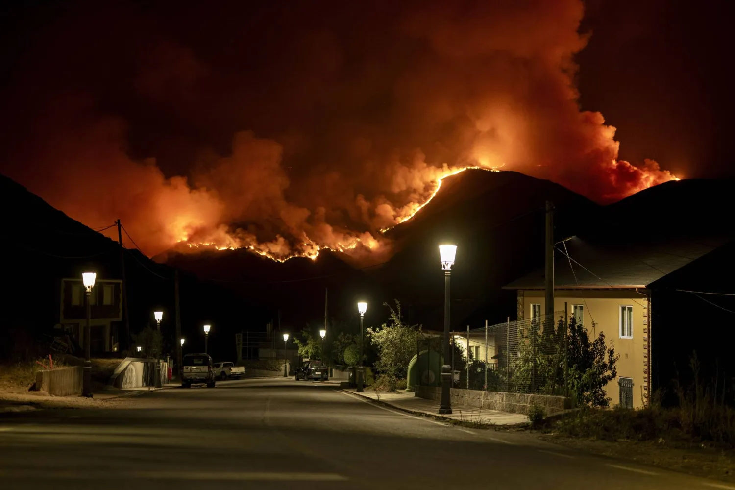 A forest fire is seen from the town of Carballeda de Valdeorras in Ourense, Galicia, northwestern Spain, late 23 August 2025 (issued 24 August 2025). EPA/BRAIS LORENZO