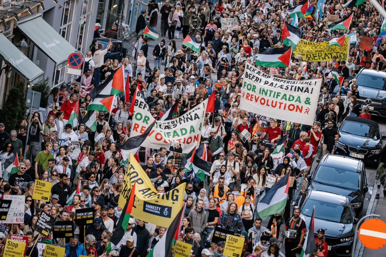 Protesters hold banners and flags during a demonstration called "All of Denmark on the streets for a free Palestine", in support of Palestinians in Gaza, amid the ongoing conflict between Israel and Hamas, in Copenhagen, Denmark August 24, 2025.  Ritzau Scanpix/Emil Nicolai Helms/via REUTERS