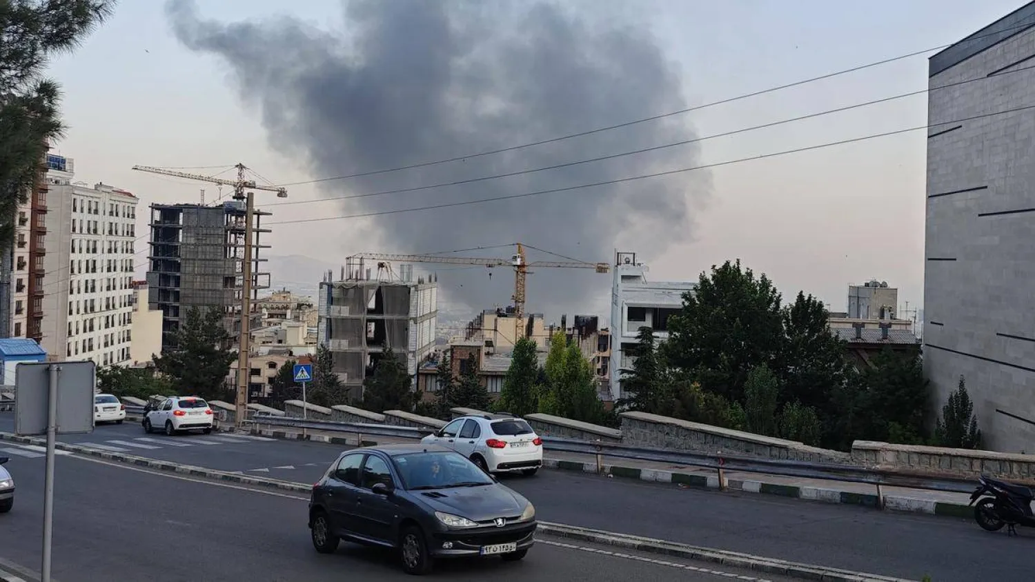 Smoke rises after a reported Israeli strike on a building used by Islamic Republic of Iran News Network, part of Iran's state TV broadcaster, on June 16, 2025 in Tehran, Iran. | Photo Credit: Getty Images 