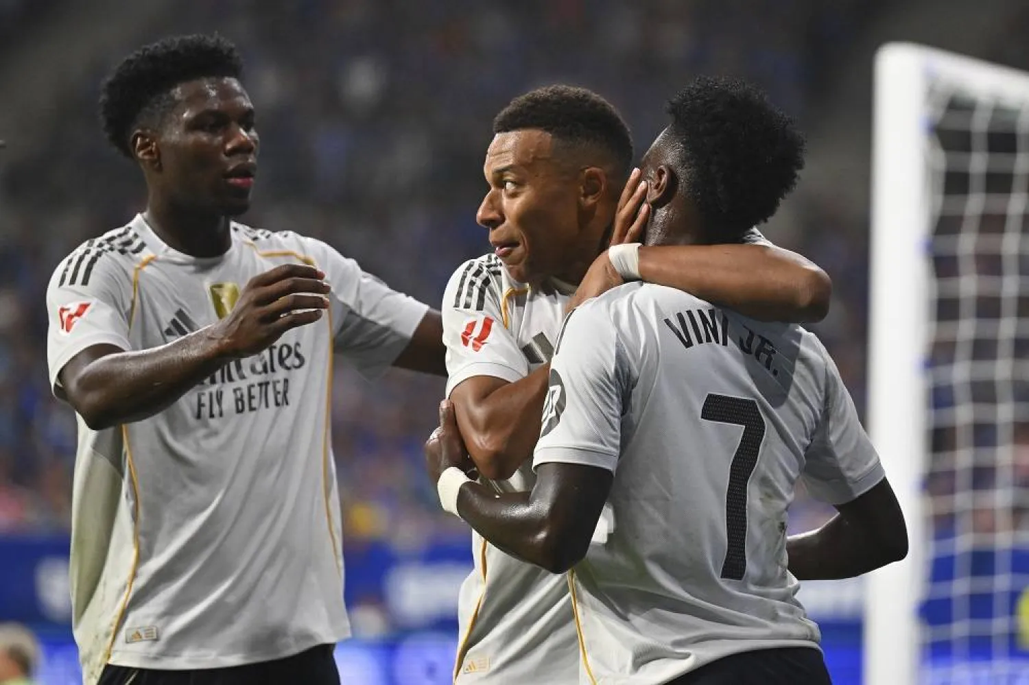 Real Madrid's Kylian Mbappe, center, is congratulated by teammates Vinicius Junior, right, and Aurelien Tchouameni after scoring his side's 2nd goal during a Spanish La Liga soccer match between Real Oviedo and Real Madrid at Carlos Tartiere stadium in Oviedo, Spain, Sunday, Aug. 24, 2025. (AP)