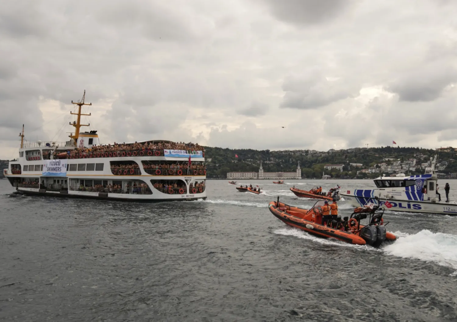 Competitors aboard a ferry heading to the start line of a 6.5-kilometer swimming race across the Bosphorus Strait, from the Asian side to the European side, in Istanbul, Türkiye, Sunday, Aug. 24, 2025. (AP Photo/Khalil Hamra)
