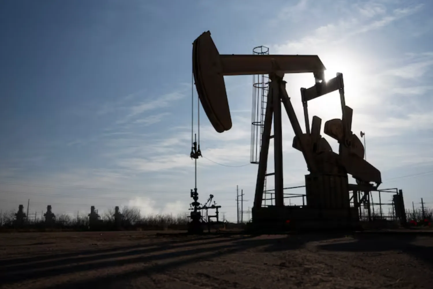 A pump jack operates near a gas turbine power plant in the Permian Basin oil field outside of Odessa, Texas, US February 18, 2025. REUTERS/Eli Hartman/ File Photo