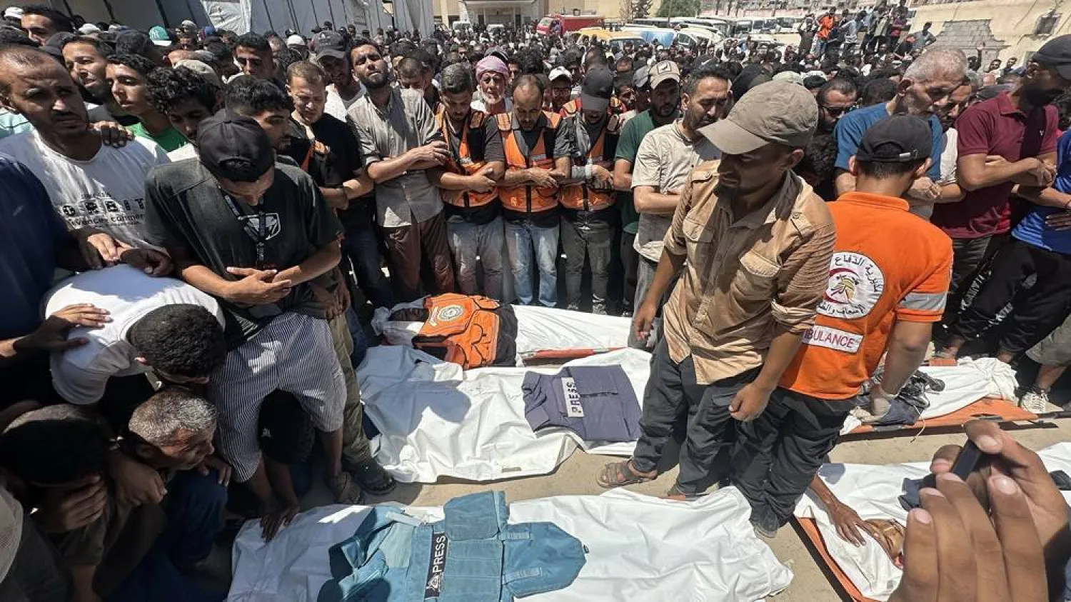People pray in front of the bodies of Palestinians killed in an Israeli airstrike at Nasser Hospital in Khan Younis, southern Gaza Strip, 25 August 2025. 