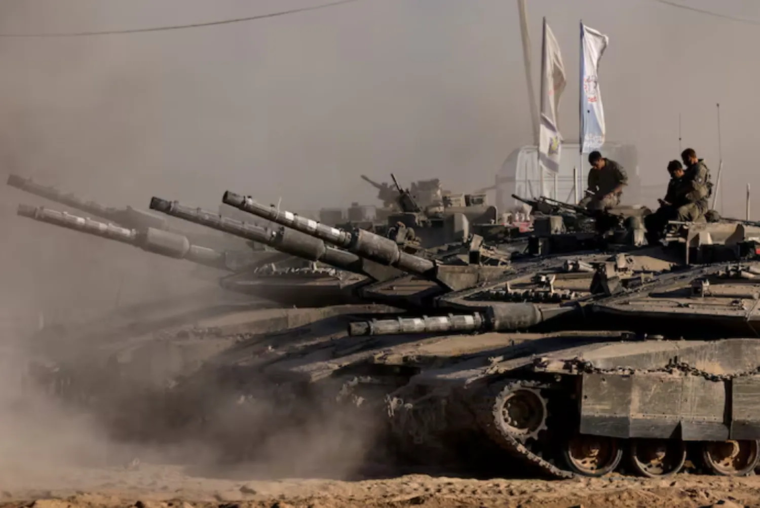 Israeli soldiers sit on top of tanks at the Israel-Gaza border, as seen from Israel, August 26, 2025. REUTERS/Amir Cohen