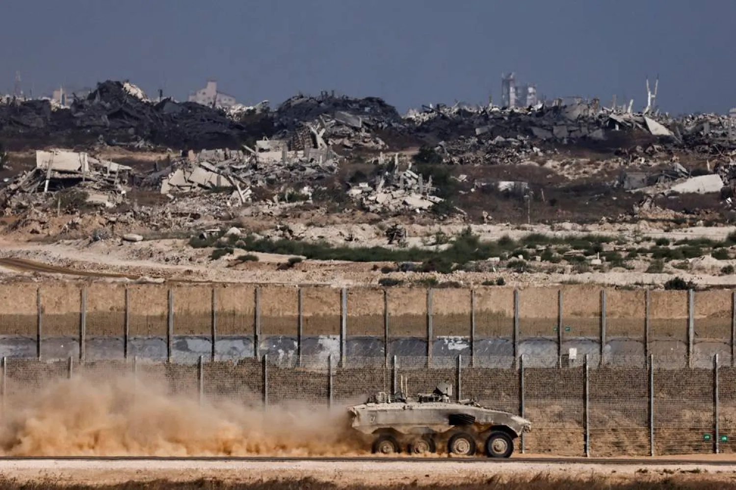  An Israeli armored personnel carrier (APC) maneuvers on the Israeli side of the border with Gaza, as seen from Israel, August 26, 2025. (Reuters)