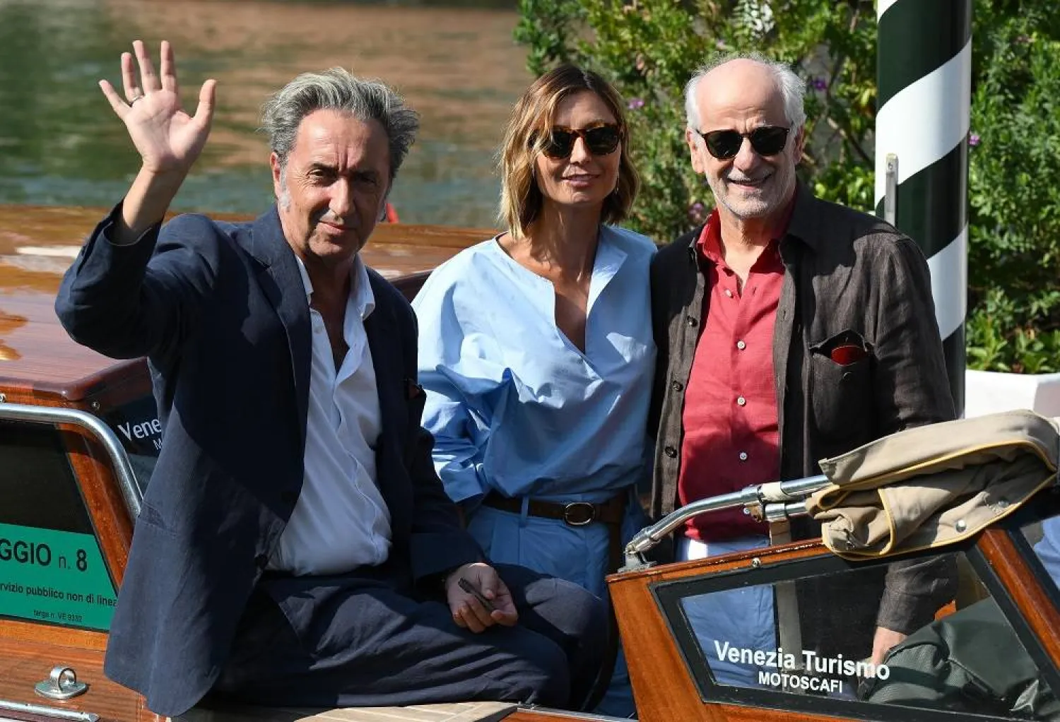 Italian filmmaker Paolo Sorrentino (L), Italian actors Anna Ferzetti (C) and Toni Servillo (R) arrive at the Lido Beach for the 82nd annual Venice International Film Festival, in Venice, Italy, 26 August 2025. (EPA)