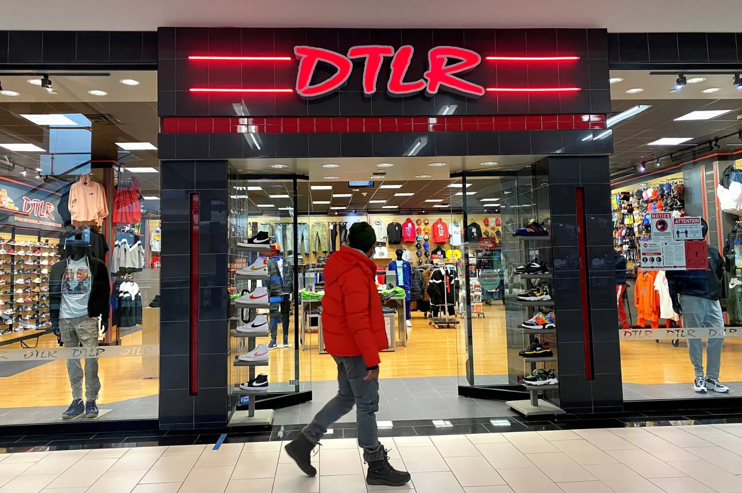 FILE PHOTO: A person walks past a DTLR sportswear store at Palisades Center Mall in West Nyack, New York, US, February 3, 2021. REUTERS/Mike Segar/File Photo