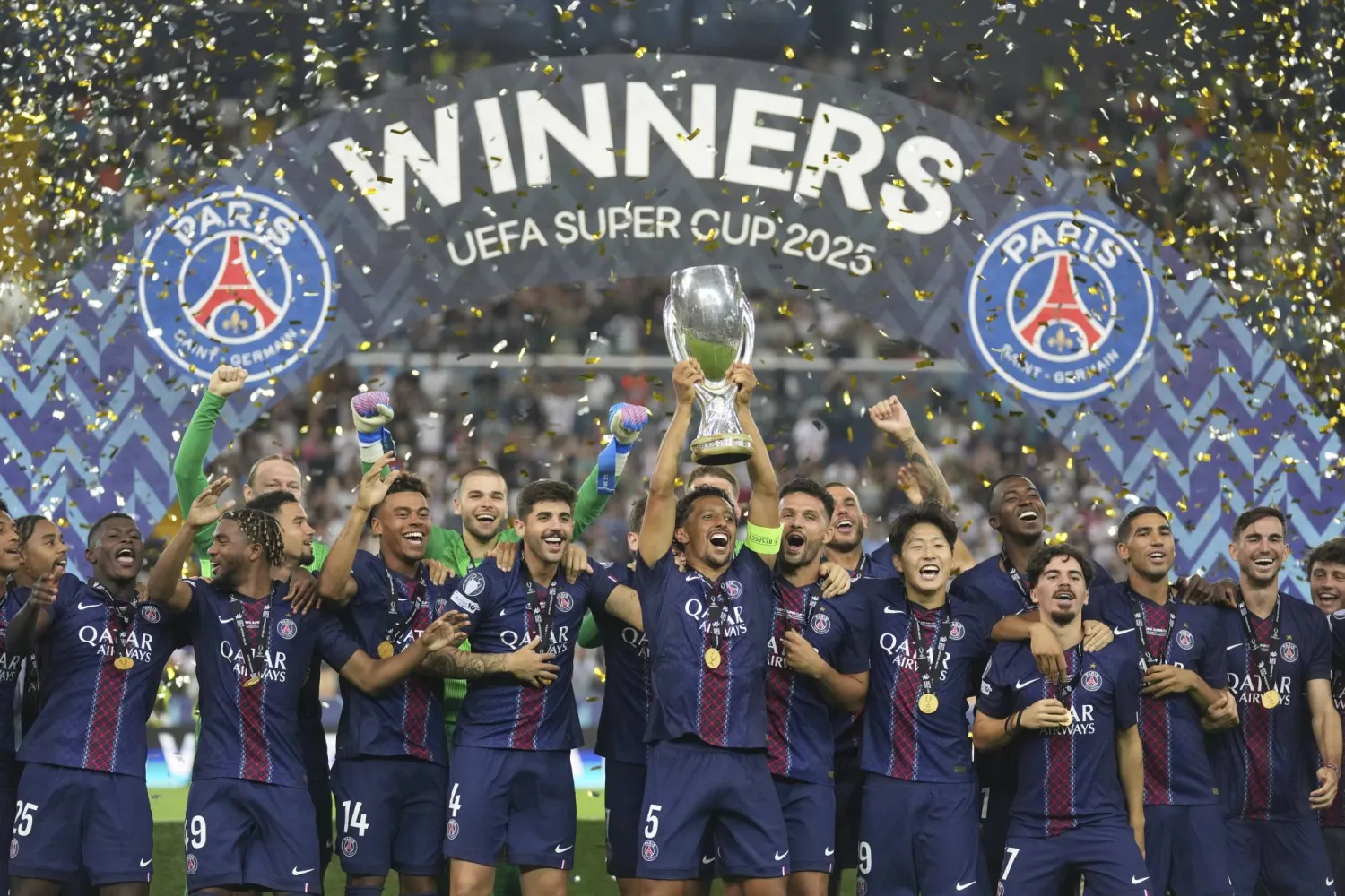 PSG's Marquinhos lifts the trophy with teammates after the UEFA Super Cup soccer match between Paris Saint-Germain and Tottenham Hotspur in Udine, Italy, Wednesday, Aug. 13, 2025. (AP Photo/Antonio Calanni)