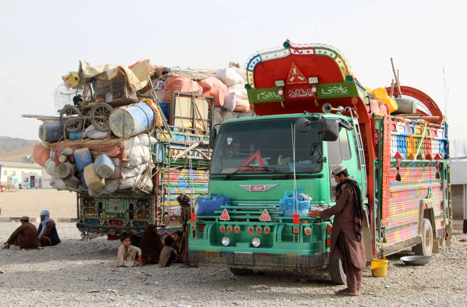 ينتظر اللاجئون العائدون من باكستان المجاورة بمخيم قبل التوجه إلى بلداتهم الأصلية في قندهار بأفغانستان الأربعاء (إ.ب.أ)