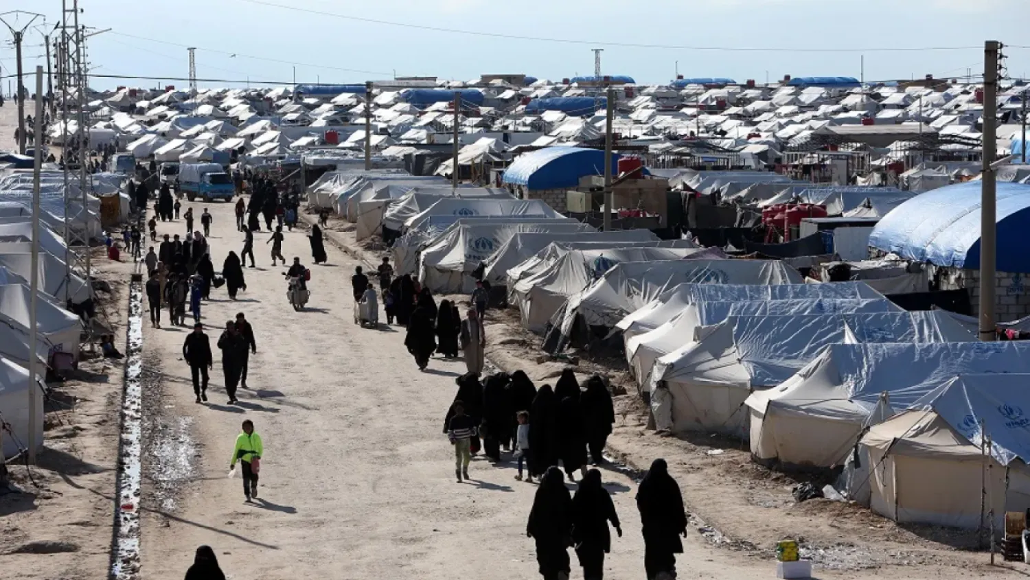 Women walk through al-Hol displacement camp in Hasakah province, Syria, April 1, 2019. (Reuters)
