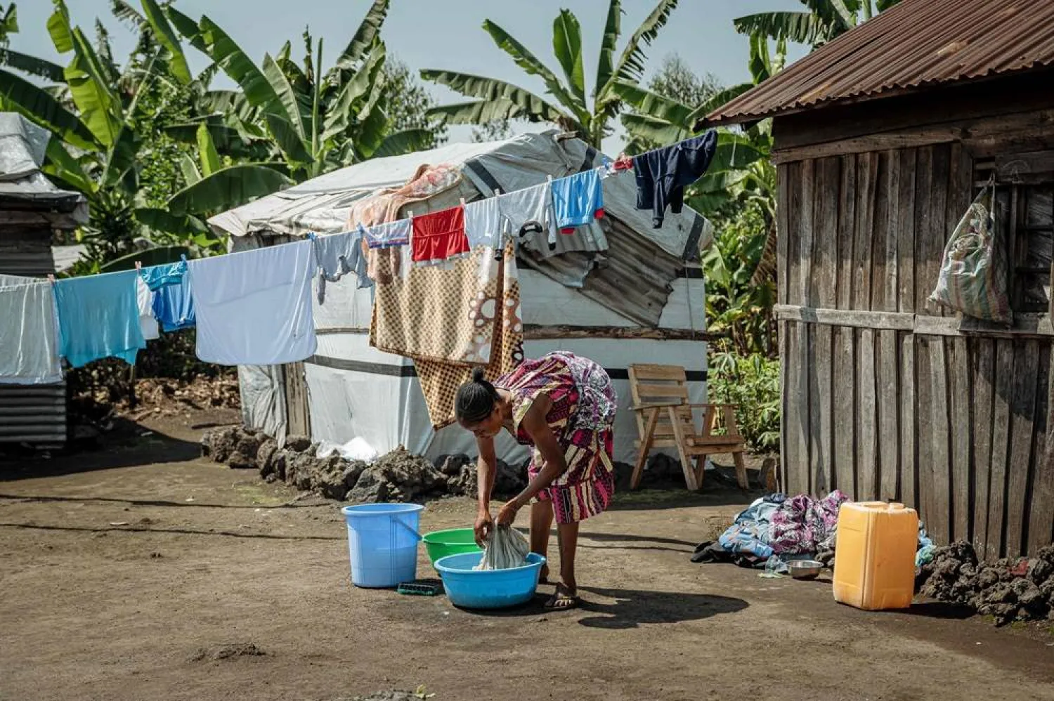 A displaced Congolese woman from Kimoka does laundry outside her shelter ahead of a visit by United Nations High Commissioner for Refugees Filippo Grandi to a camp in Sake, eastern Democratic Republic of Congo, on August 29, 2025. (AFP)
