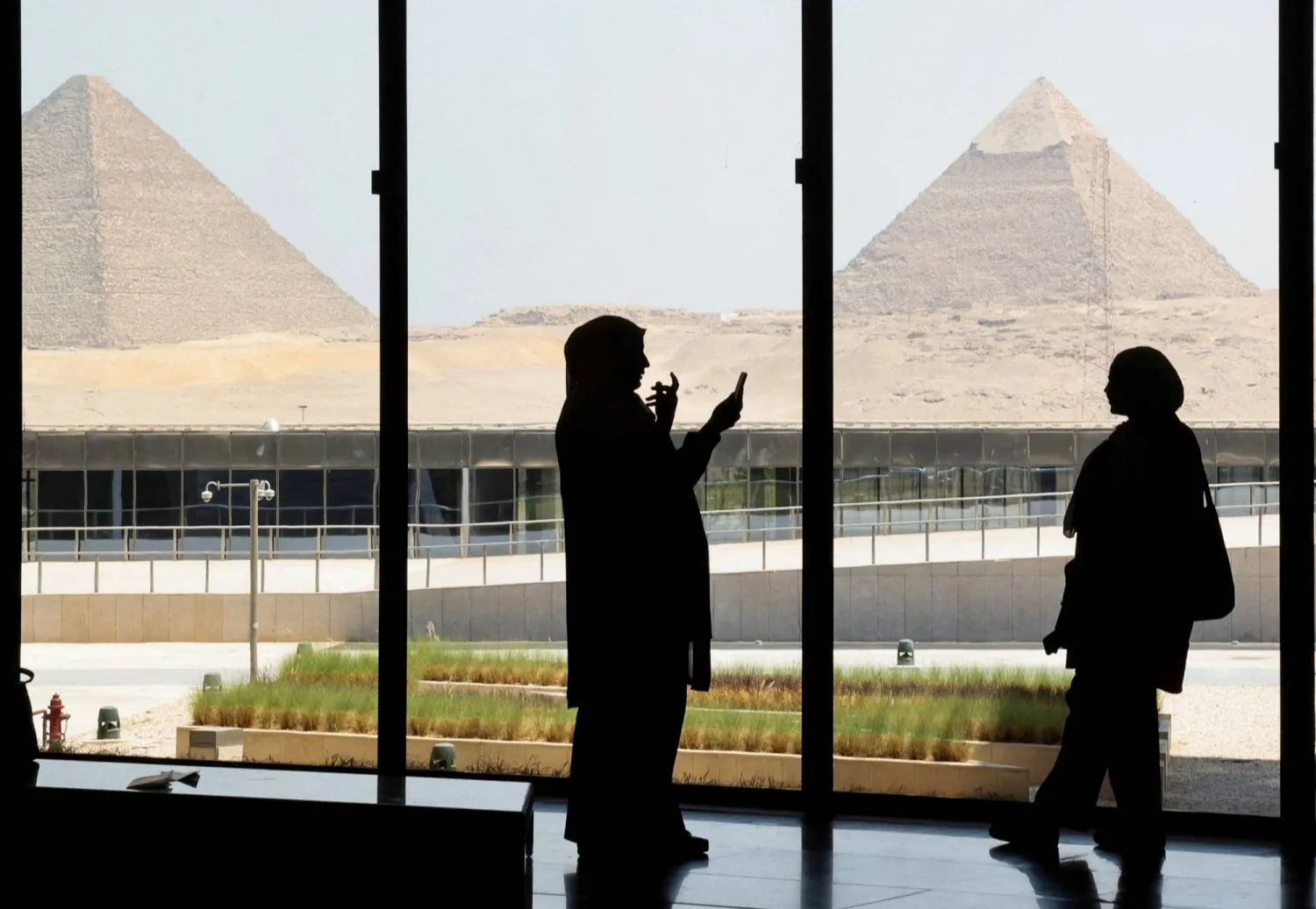 FILE PHOTO: Egyptians take pictures with the pyramids in the background as they visit the Grand Egyptian Museum on the southwestern outskirts of the capital Cairo, Egypt, June 2, 2025. REUTERS/Amr Abdallah Dalsh/File Photo