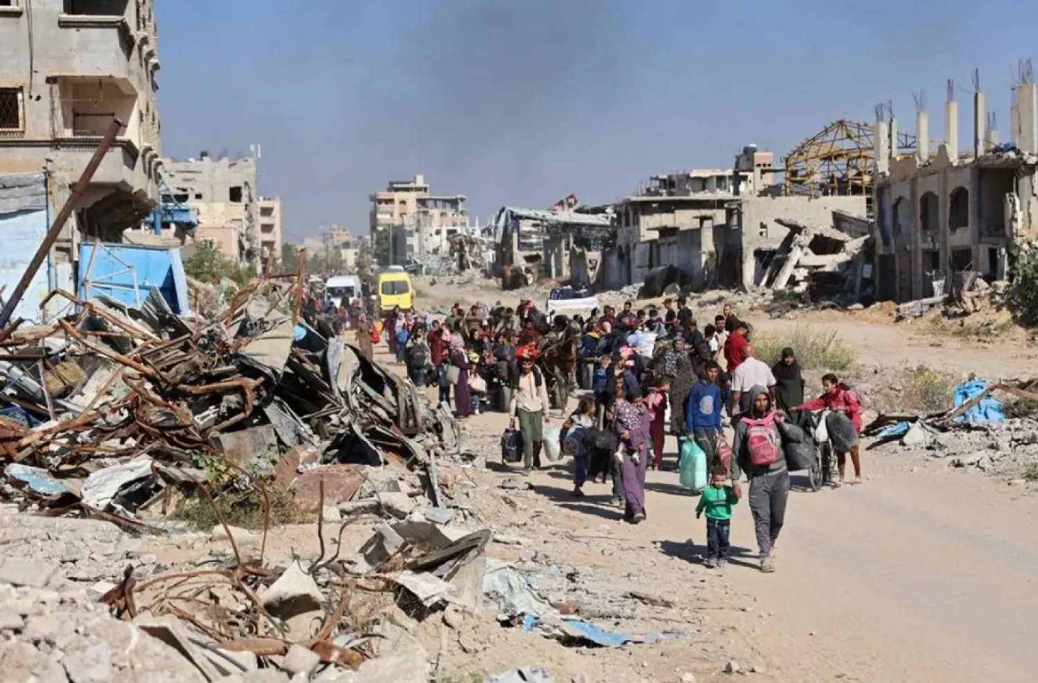 Displaced Palestinians fleeing Israeli military operations in Beit Lahia in the northern Gaza strip walk along the Salah al-Din main road in eastern Gaza City making their way to the city center, on October 22, 2024, amid the ongoing war in the Palestinian territory between Israel and Hamas. (AFP)
