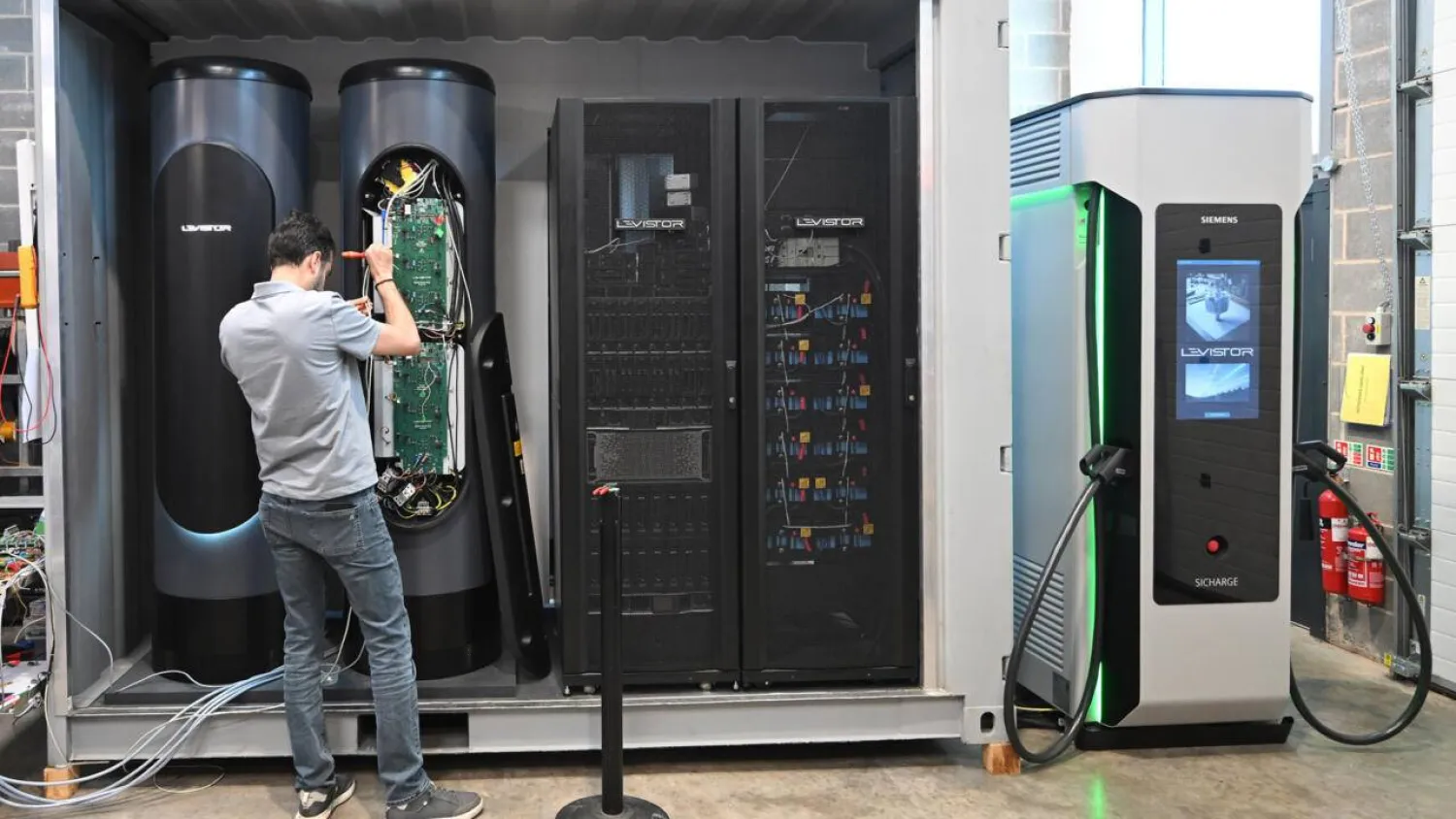 An engineer works on a flywheel energy storage system at Levistor's workshop in southwest London. Justin TALLIS / AFP
