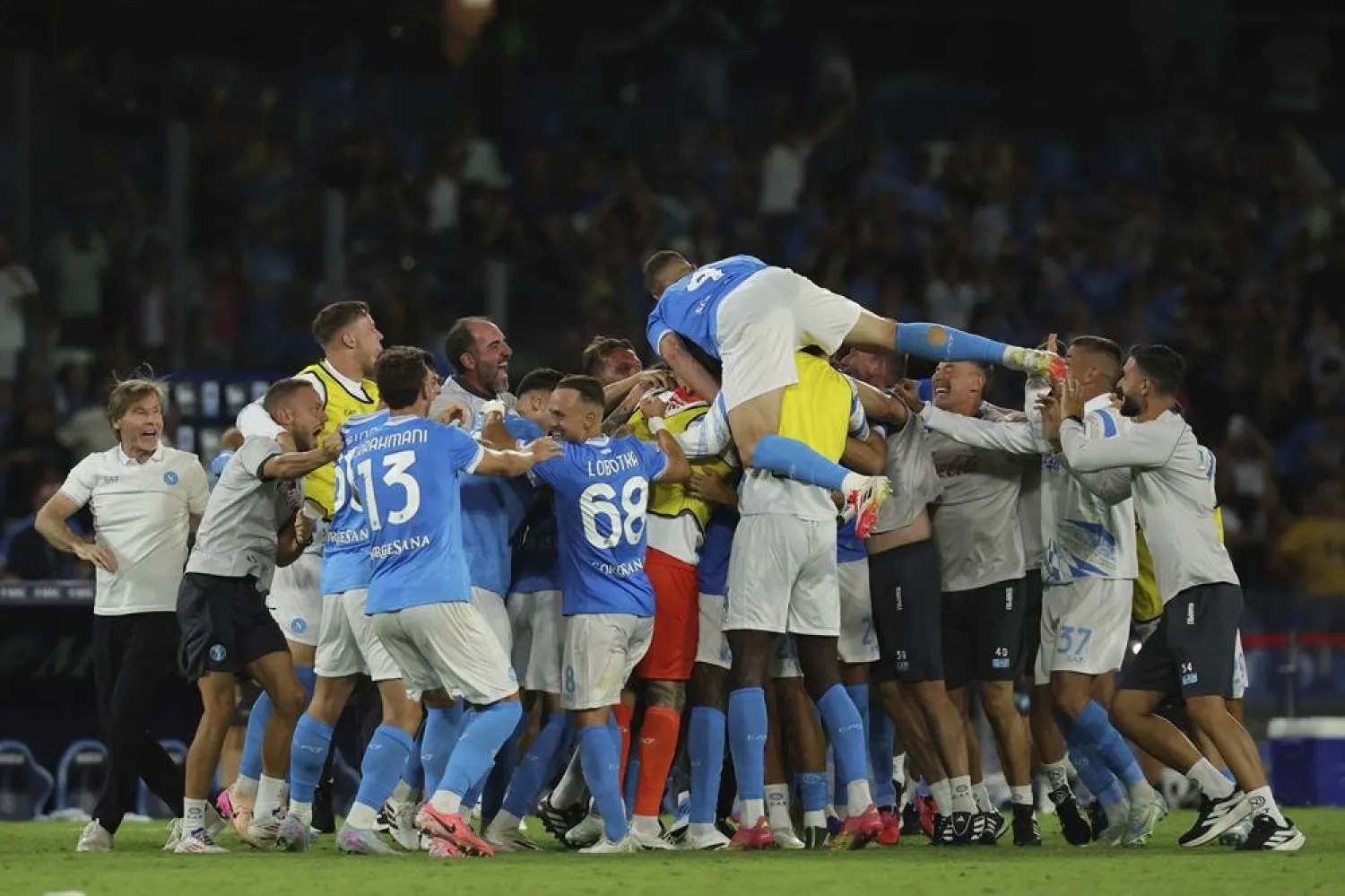 Napoli players celebrates teammate Andre-Frank Zambo Anguissa's goal during the Serie A match between Napoli and Cagliari at the Diego Armando Maradona Stadium in Naples, southern Italy, Saturday, Aug. 30, 2025. (LaPresse via AP)