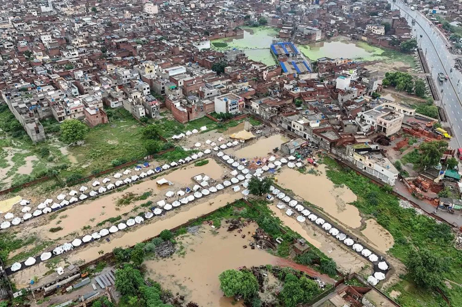 This aerial view shows makeshift shelters built for flood-affected people in Chung, in Pakistan's Punjab province, on August 31, 2025. (AFP)