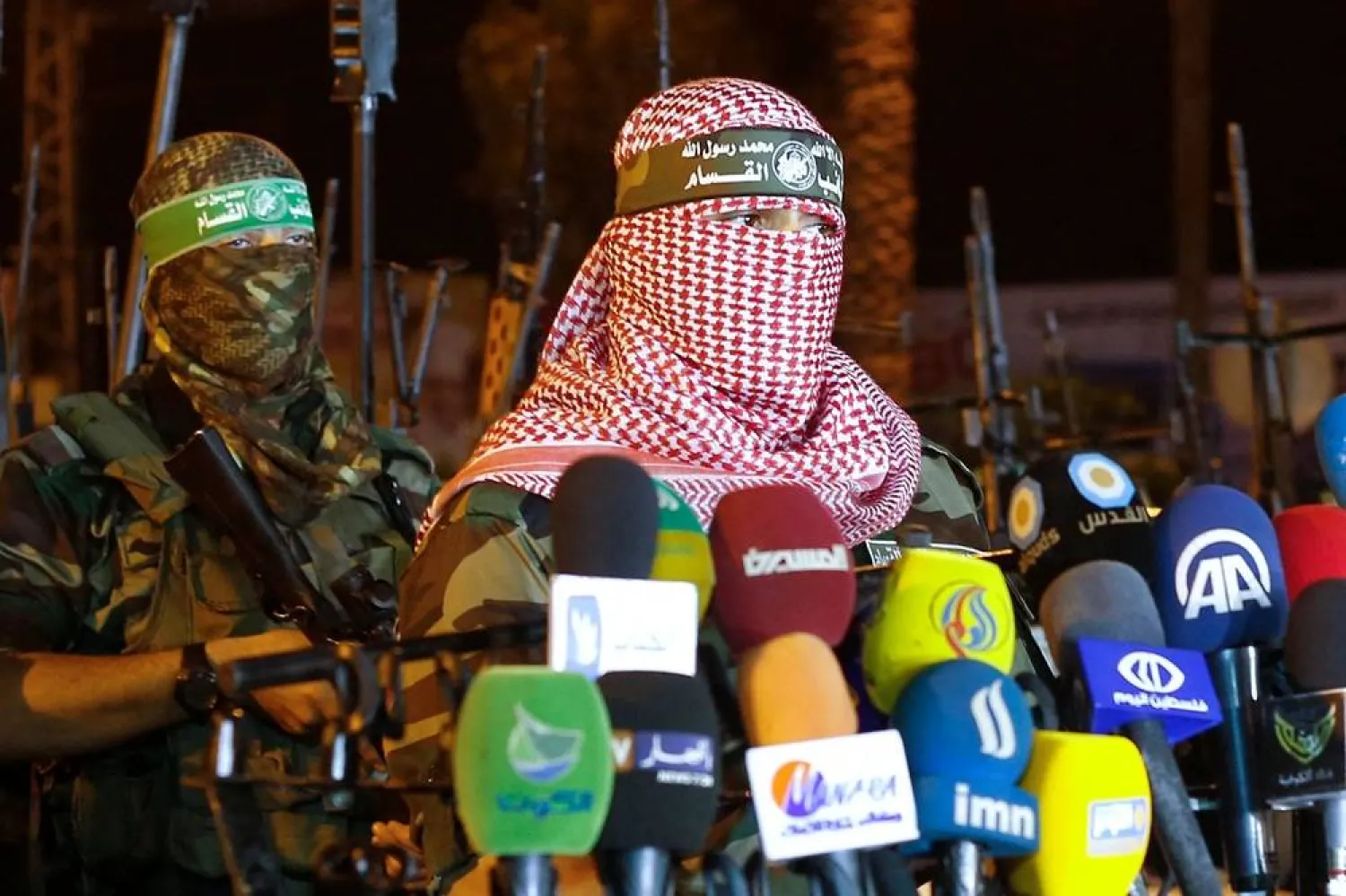 Abu Obeida (R), spokesman for the armed wing of Hamas, the Ezzedine al-Qassam Brigades, delivers a statement in Gaza City late on July 8, 2015. (AFP)