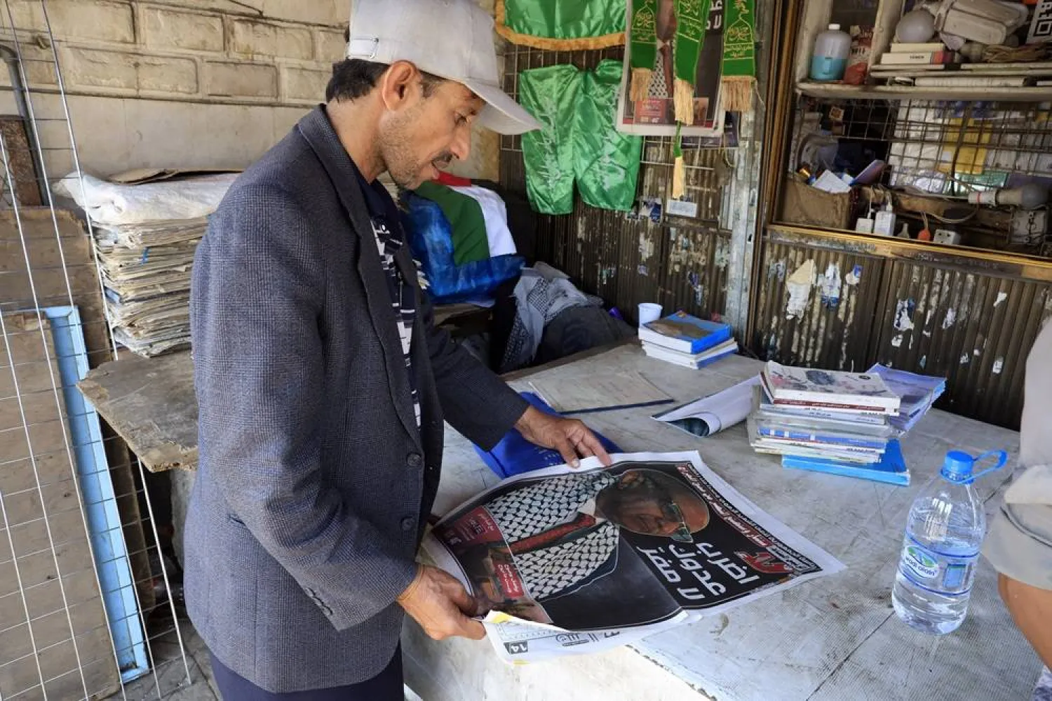 A person reads a local newspaper publishing news and portrait of Houthi illegitimate government's Prime Minister Ahmed Ghaleb Nasser Al-Rahawi, after the Houthis announced his death in recent Israeli strikes, in Sanaa, Yemen, 31 August 2025. (EPA) 