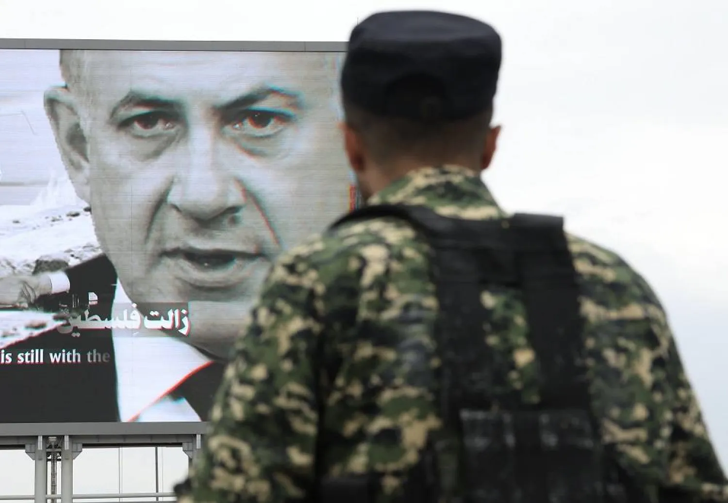 A Houthi fighter stands guard in front of a digital billboard featuring Israeli Prime Minister Benjamin Netanyahu, during a protest against Israel in Sanaa, Yemen, 29 August 2025. (EPA)