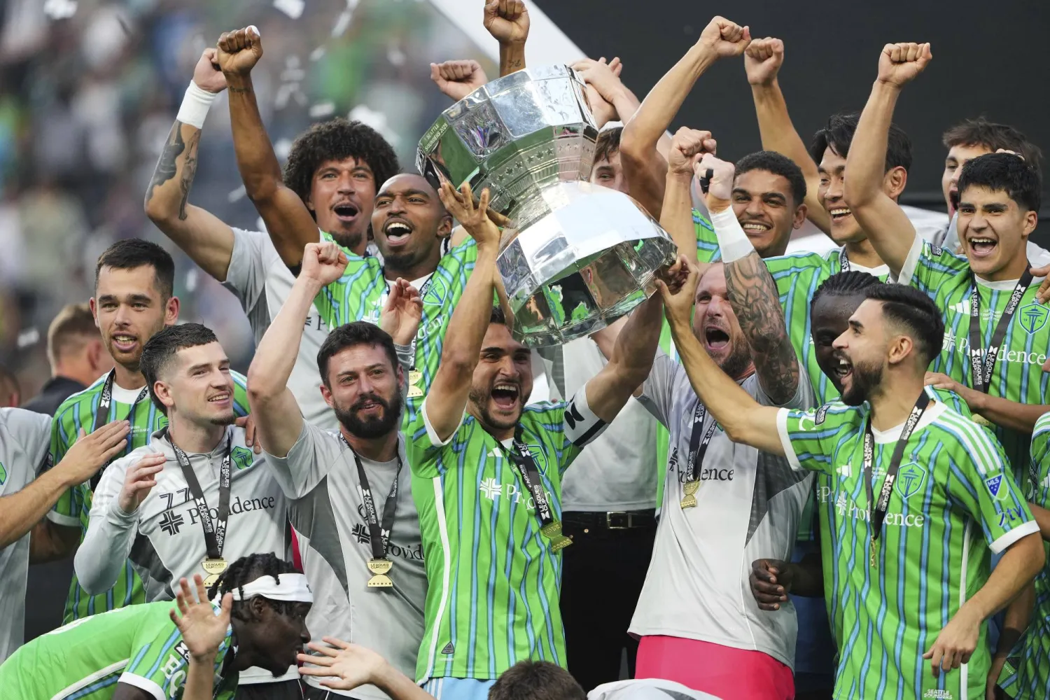 Seattle Sounders midfielder Cristian Roldan lifts the Leagues Cup trophy as he celebrates with teammates after beating Inter Miami in a Leagues Cup final soccer match Sunday, Aug. 31, 2025, in Seattle. (AP Photo/Lindsey Wasson)