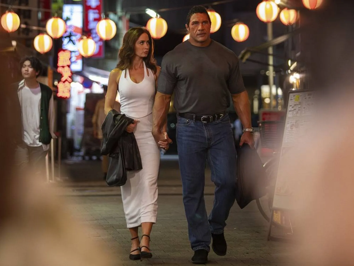 This image released by A24 shows Emily Blunt, left, and Dwayne Johnson in a scene from "The Smashing Machine." (Ken Hirama Dunn/A24 via AP)