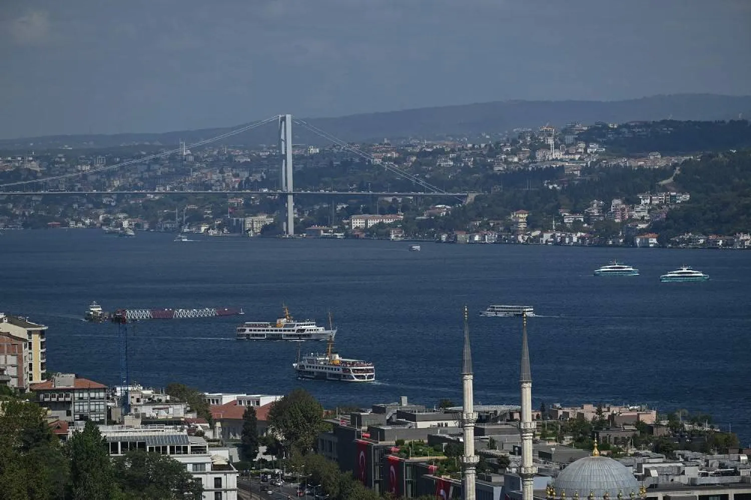 Ferries sail the Bosphorus in Istanbul, on August 29,2025, next to the 15 July Martyrs Bridge, known as Bosphorus bridge. (AFP) 