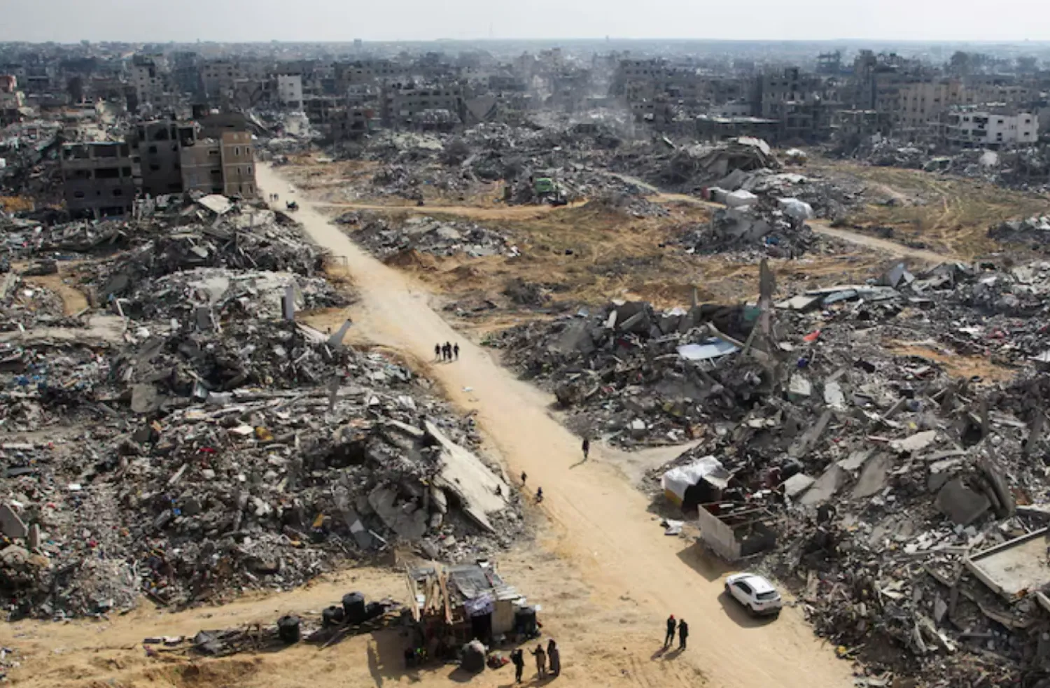 Palestinians walk past the rubble of buildings destroyed during the Israeli offensive, in Rafah in the southern Gaza Strip, February 4. REUTERS/Hatem Khaled