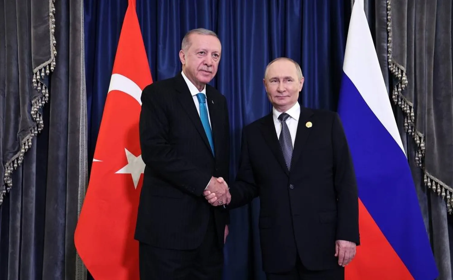 01 September 2025, China, Tianjin: Russian President Vladimir Putin (R) shakes hands with Turkish President Recep Tayyip Erdogan ahead of a joint meeting on the sidelines of the 25th Heads of State Council meeting of the Shanghai Cooperation Organization (SCO). (Kremlin/dpa) 