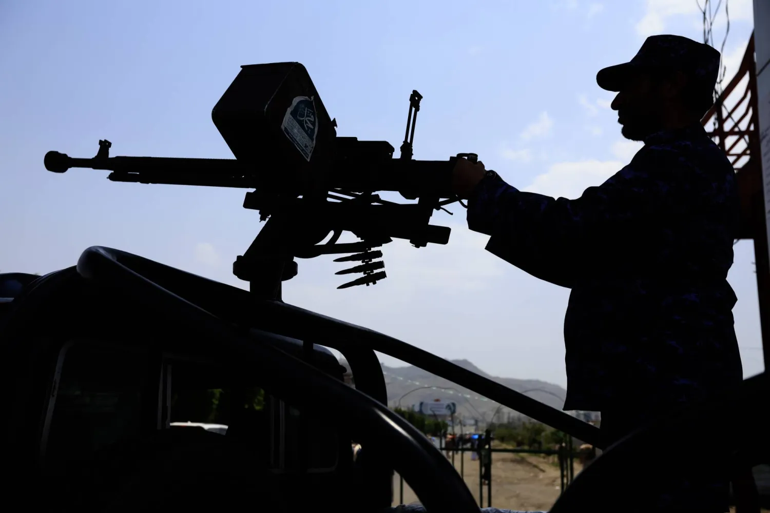 مسلح «حوثي» يظهر خلف مدفع رشاش على شاحنة صغيرة في أثناء دورية بصنعاء (إ.ب.أ)